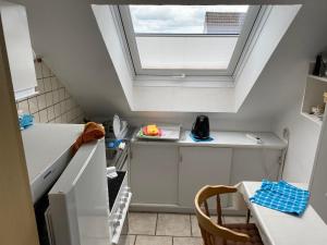 a small kitchen with a skylight in the ceiling at Ferienwohnung mit Loggia in Warstein