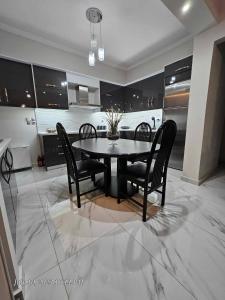 a kitchen with a black table and black chairs at Luxury and Cozy Chios in Chios