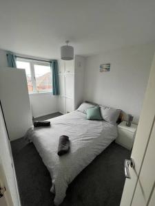 a bedroom with a bed in a room with a window at Homely 3 bed town centre flat in Peterhead
