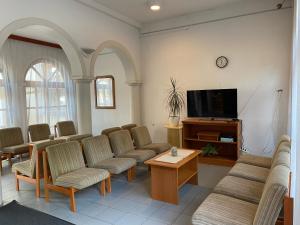 a waiting room with chairs and a flat screen tv at Sio Hostel in Siófok