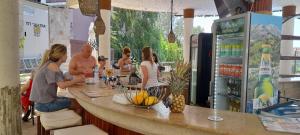 a group of people sitting at a counter in a bar at Sunny Beach Hills Apartment - Private in Sunny Beach