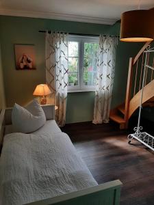 a bedroom with a bed and a staircase and a window at Seeliebe mit Sauna und nur 50 mtr. bis zum Strand in Senftenberg