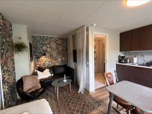 a living room with a couch and a table at Havsbadens B&B in Ängelholm