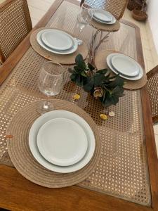 a table with plates and wine glasses on it at Departamentos Cristo del Portezuelo in Chilecito
