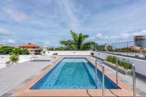 a swimming pool on the roof of a building at Hotel Stay Here Suites in Santo Domingo