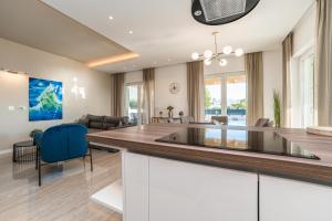 a dining room and living room with a glass table at Exclusive luxury Villa with glorious sea view - by TA Leut Agency in Privlaka