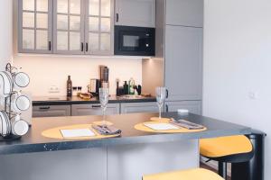 a kitchen with two wine glasses on a counter at Lakeside Traunsee Apartment in Altmünster