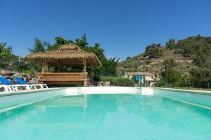a large swimming pool with a gazebo at Domaine Saint Julien in Buis-les-Baronnies