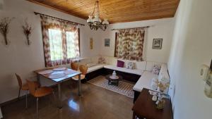 a living room with a couch and a table at Crissimo apartment in Panagia