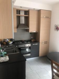 uma cozinha com um lavatório e um fogão forno superior em Da Giuditta FreeCarPark&Garden em Domodossola