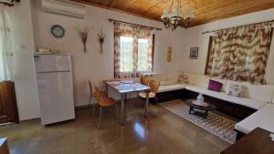 a living room with a couch and a table at Crissimo apartment in Panagia +10 photos