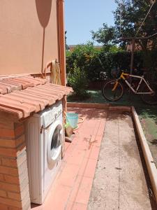 a washing machine sitting outside of a house at Home Life in Venturina Terme