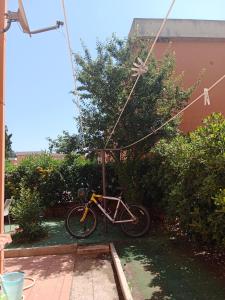 a bike is parked in a garden at Home Life in Venturina Terme