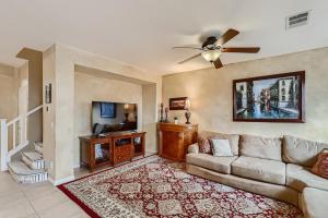 a living room with a couch and a tv at The Winner’s Retreat in Las Vegas