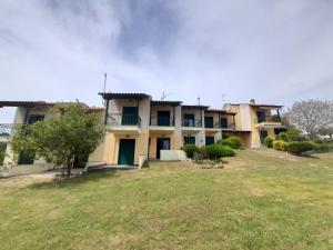 a large house with a yard in front of it at Roxane in Hanioti