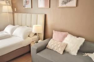 a living room with a couch and a chair at Quince Studio w/ Balcony Orochi Staycation PH at Loop Tower CDO in Cagayan de Oro