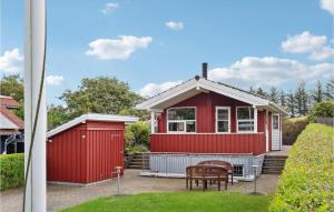 a red tiny house with a table and chairs at Stunning Home In Esbjerg V With Kitchen in Esbjerg
