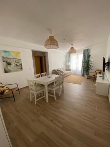 a living room with a white table and chairs at Casa da Amoreira in Odeceixe +5 photos