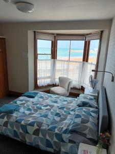 a bedroom with a bed with a view of the ocean at Burlington in Margate