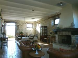 a living room with a couch and a fireplace at Casale con vista sui Monti Sibillini e piscina in Amandola