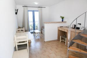 a living room with a table and a desk at Elpida Village in Istro