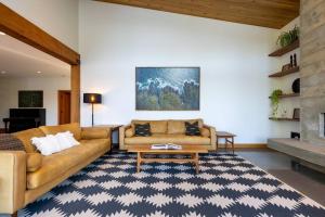 a living room with a couch and a table at Tree Fern Guest House in Tofino