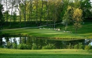 a golf course with a reflection in the water at Gwen's Place - Private 2nd Floor in Saint Ansgar