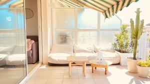 a living room with a couch and a table at Vue mer à couper le souffle - nouveau entièrement rénové in Cannes
