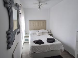a bedroom with a bed with two towels on it at The 2 bed-Roof terrace-apartment in Málaga