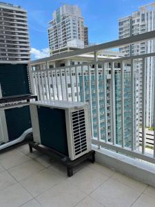 a balcony with an air conditioner on a building at 2BR spacious stylish condo near mall in Cebu City
