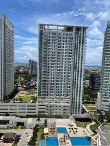 a view of a tall building in a city at 2BR spacious stylish condo near mall in Cebu City