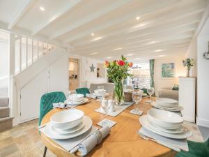 a dining room with a wooden table with chairs and a dining room at The Firs in Carbis Bay