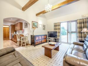 a living room with a couch and a table at The Stables - Uk44515 in North Thoresby