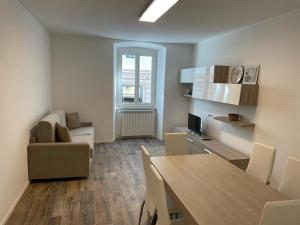 a living room with a table and a dining room at CASA VACANZE GINEVRA 1 in Trieste