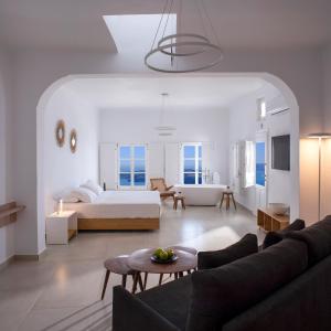 a living room with a bed and a couch at Elia Family Suites in Fira