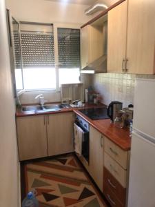 a small kitchen with a sink and a stove at Lili's House Golem, Durres in Golem