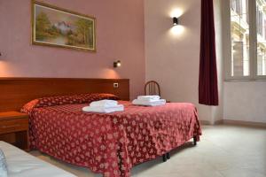 Postel nebo postele na pokoji v ubytování Bye Rome Guesthouse