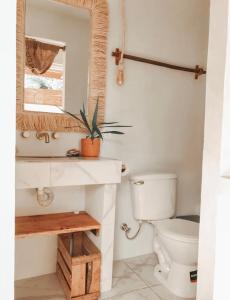 a bathroom with a toilet and a sink and a mirror at Ayampe Lofts - Private Terrace in Ayampe