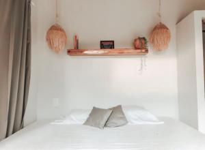 a bedroom with a bed and a shelf on the wall at Ayampe Lofts - Private Terrace in Ayampe