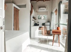 a white room with a table and a kitchen at Ayampe Lofts - Private Terrace in Ayampe