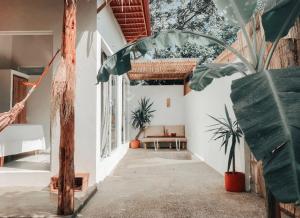 a room with a porch with a bench and plants at Ayampe Lofts - Private Terrace in Ayampe