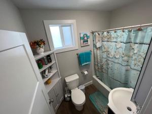 a bathroom with a shower and a toilet and a sink at 1BR/BA Condo w/Patio - 8 min to Wildwood Beach/Boardwalk in Wildwood