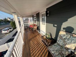 a porch with a bench and a table on a house at 1BR/BA Condo w/Patio - 8 min to Wildwood Beach/Boardwalk in Wildwood