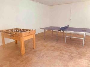 two ping pong tables in a room with a ping pong table at CASA RURAL VILLARRUBIA in Villarrubia de los Ojos