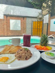 una mesa con dos platos de desayuno. en Hotel Torre del Viento cali, en Cali