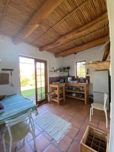 a living room with a table and a desk at Belle vallée Cottage in Greyton