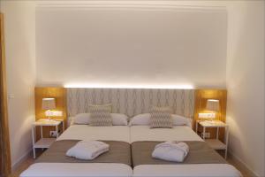 a bedroom with two beds and two night stands at Sóller Center in Sóller