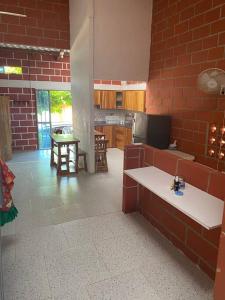 cocina con pared de ladrillo rojo en Villa Celeste, en Arboletes