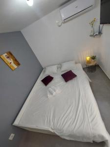 a large white bed in a white room at Vita in Bribir