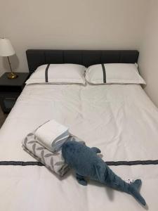 a stuffed blue fish laying on a bed at Tranquil Retreat near Vancouver's Top Attractions in Vancouver
